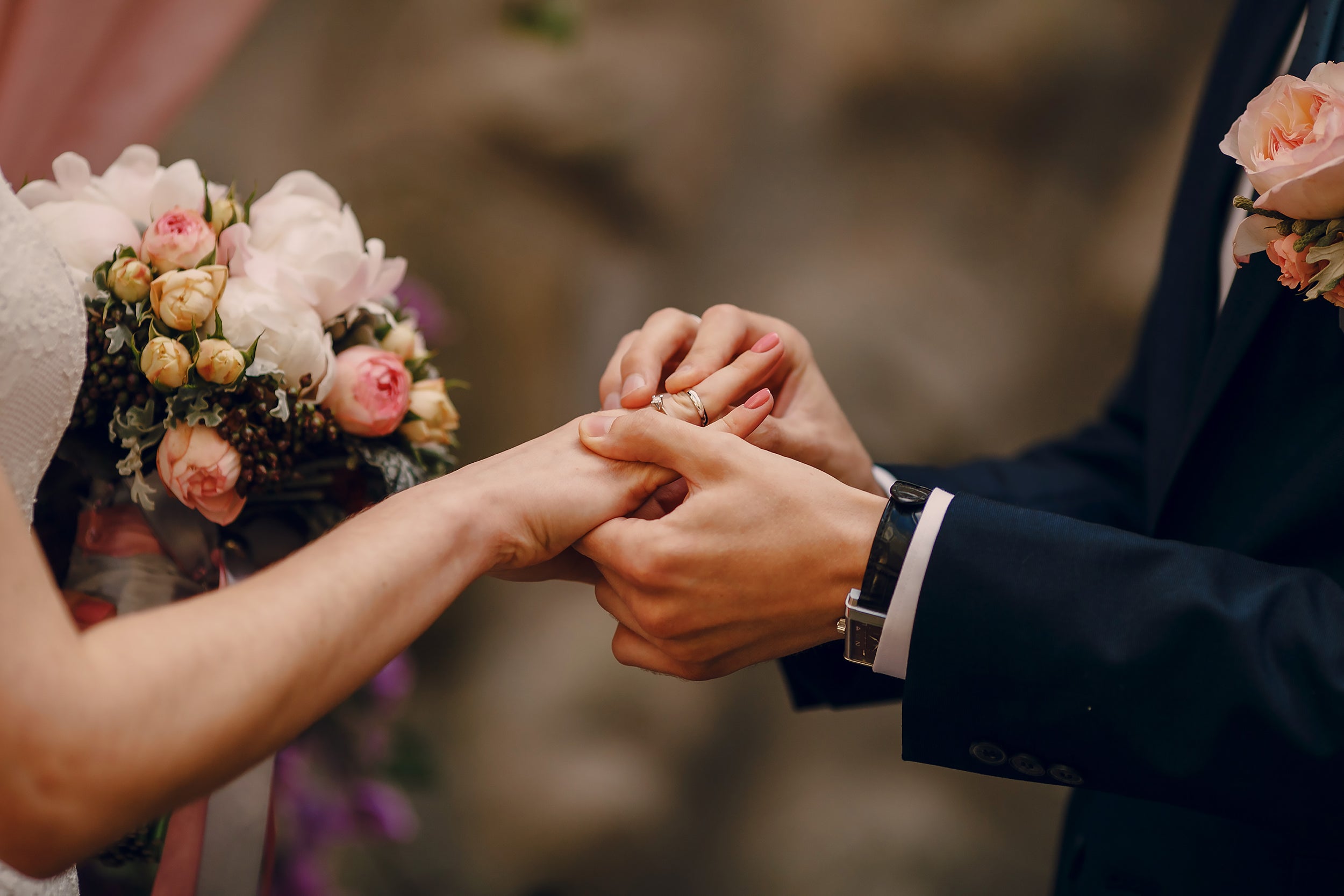 Formal flower bouquet on wrist at event.
