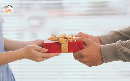 person giving a gift to another