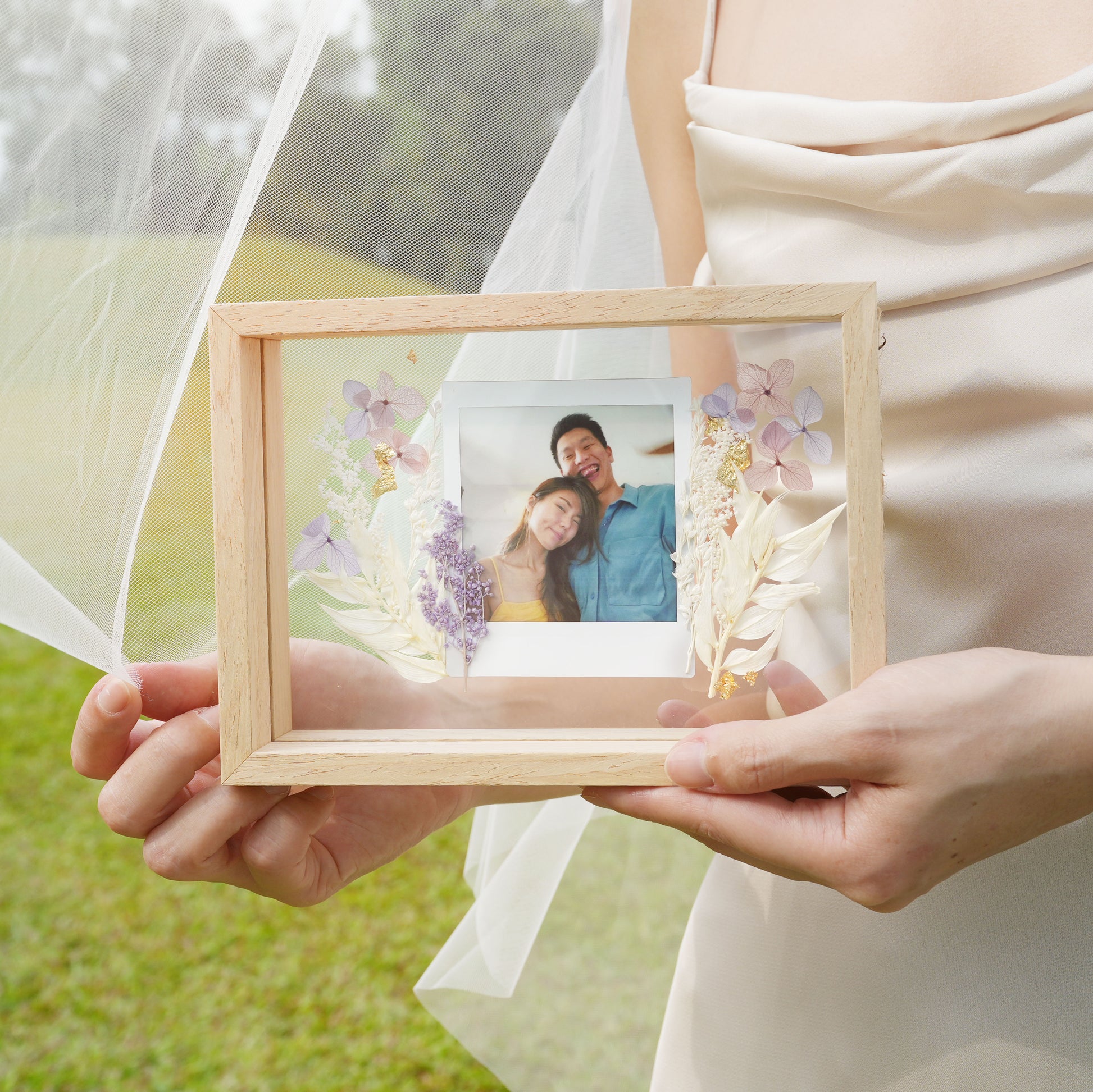 frame with polaroid film and flowers