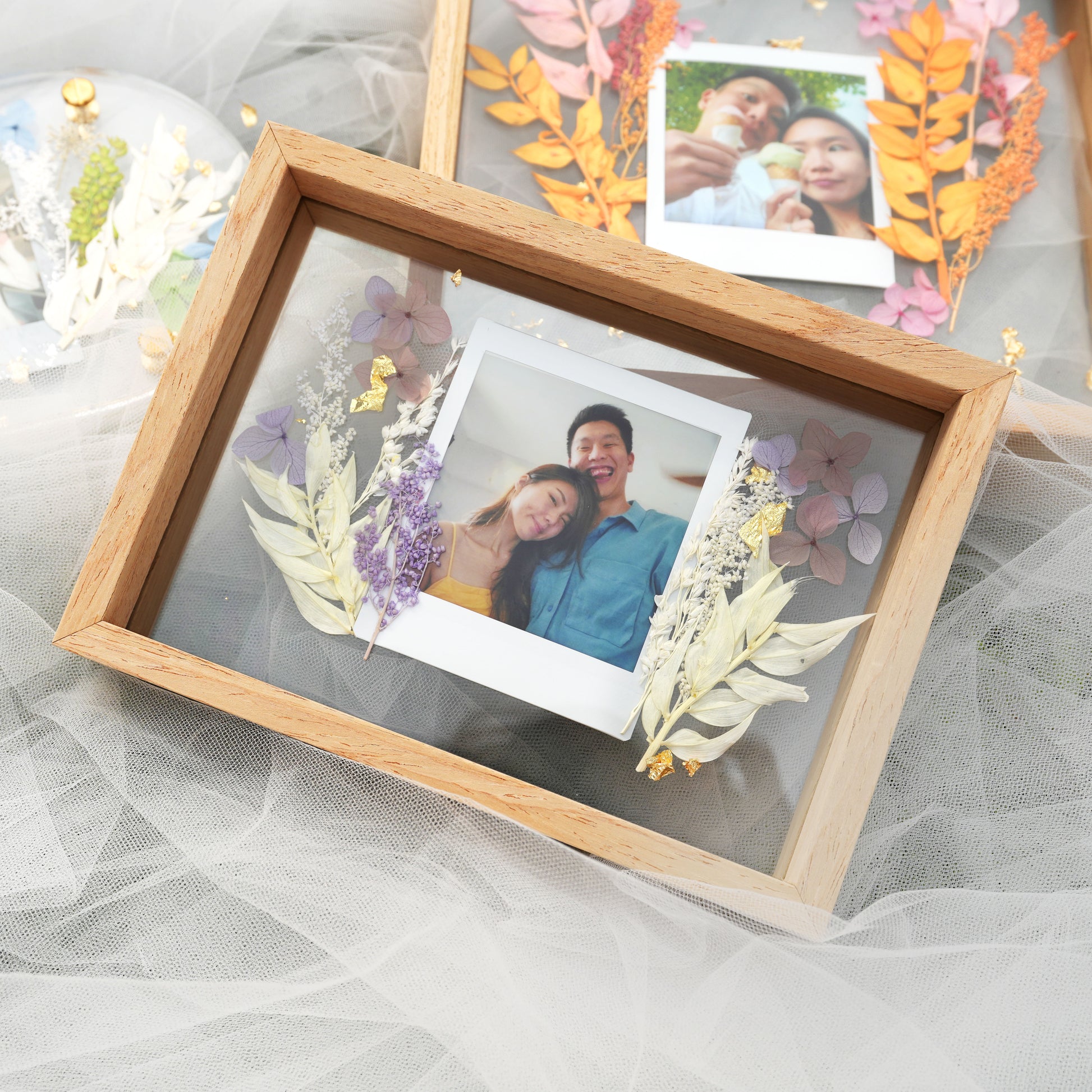 lightwood frame with polaroid film and flowers