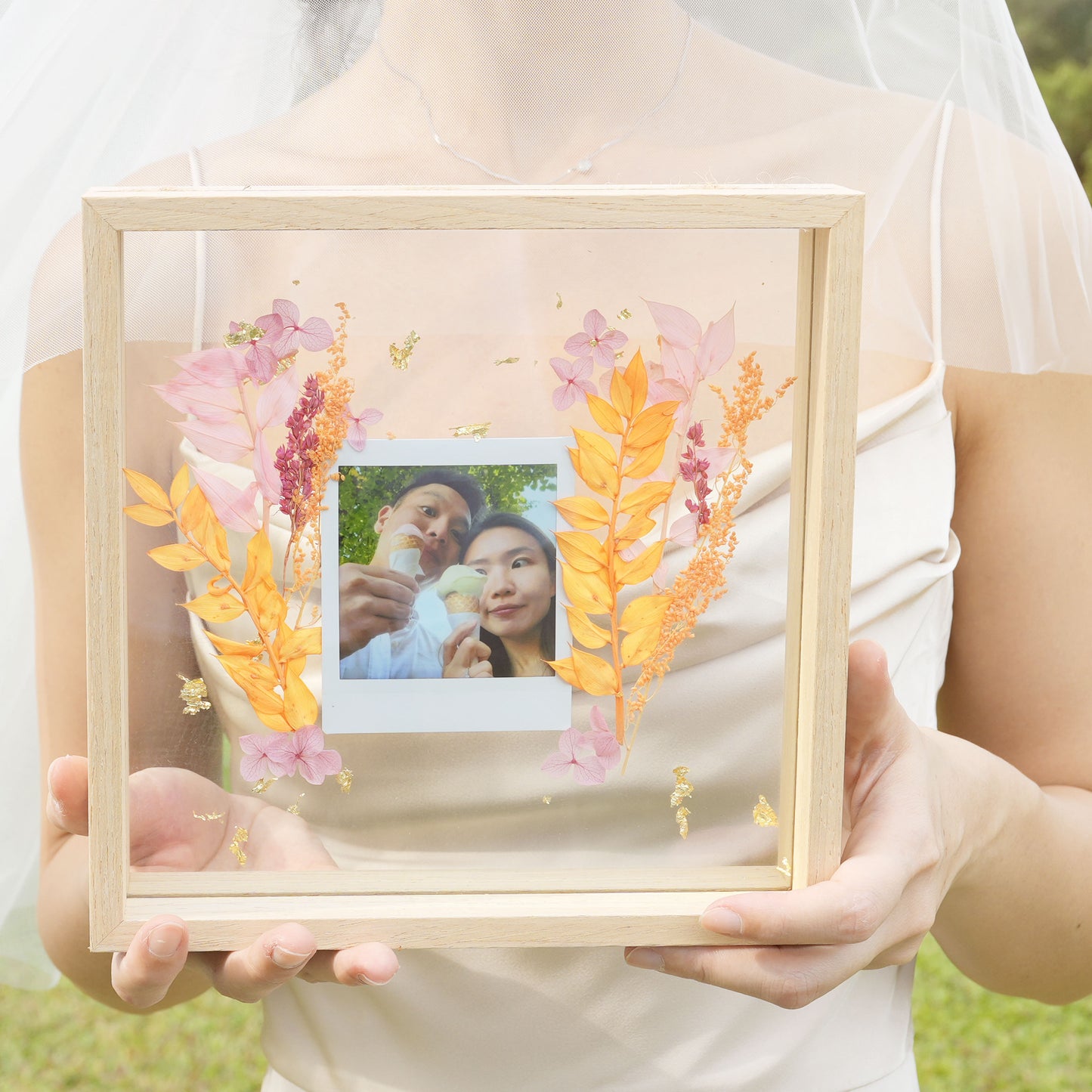 square frame with polaroid and pressed flower