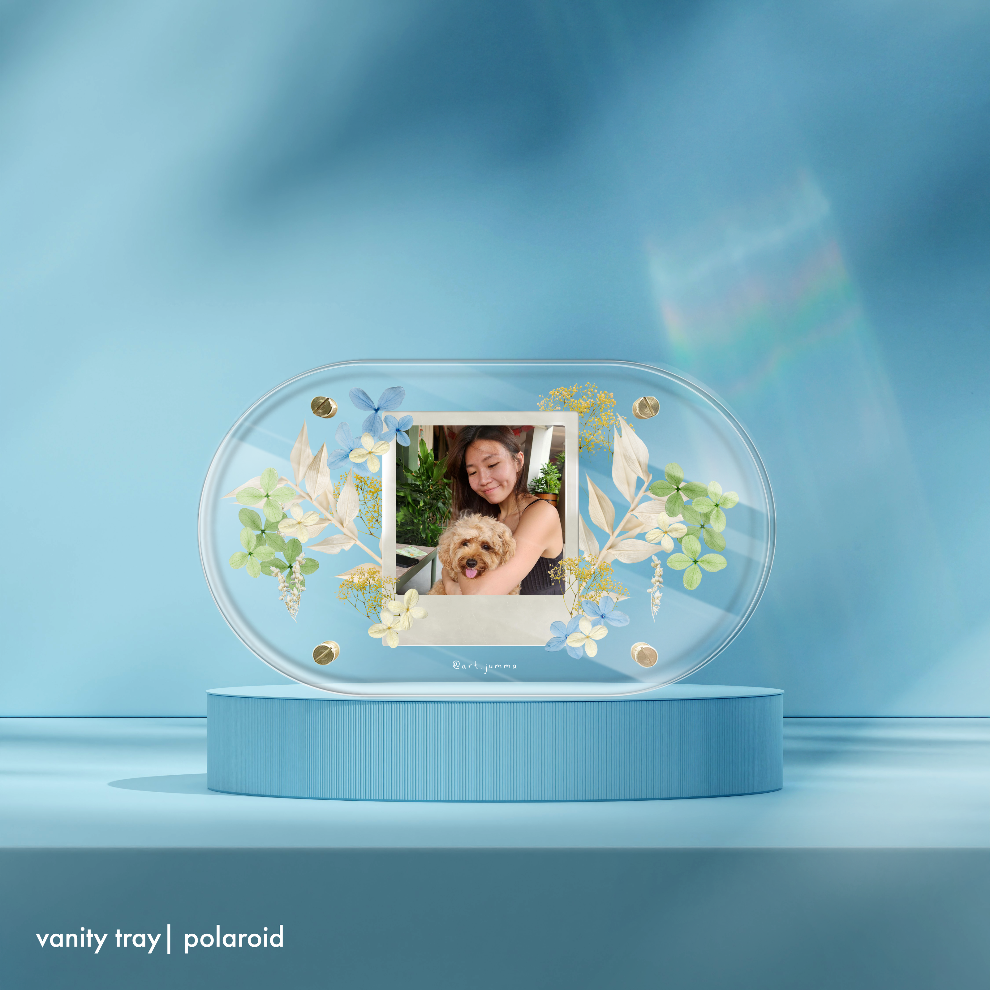 Person holding vanity tray with polaroid.